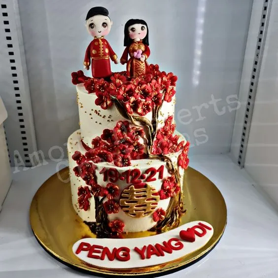 Red blossom custom cake with double happiness detail and couple toppers